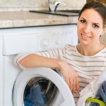 happy-woman-leaning-washing-machine_23-2148386988